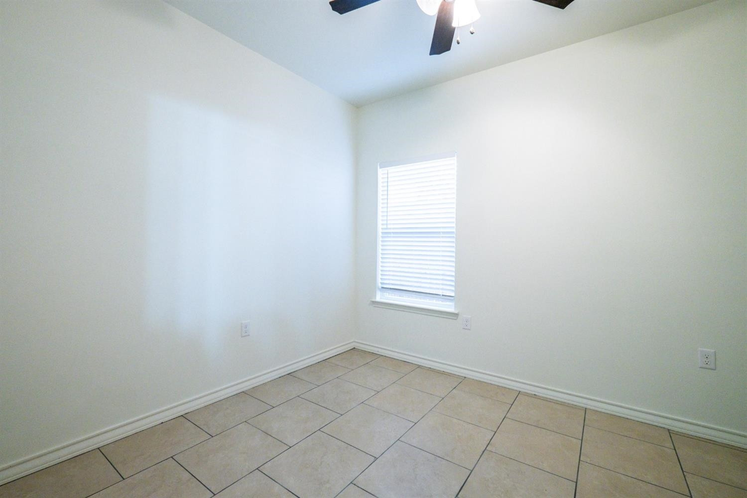 2311 20th Street Lubbock, TX 79411 - Photo 9 of 18 an empty room with a empty space and windows