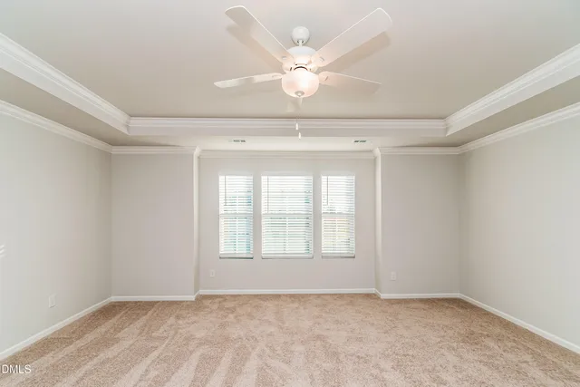 an empty room with closet and a ceiling fan