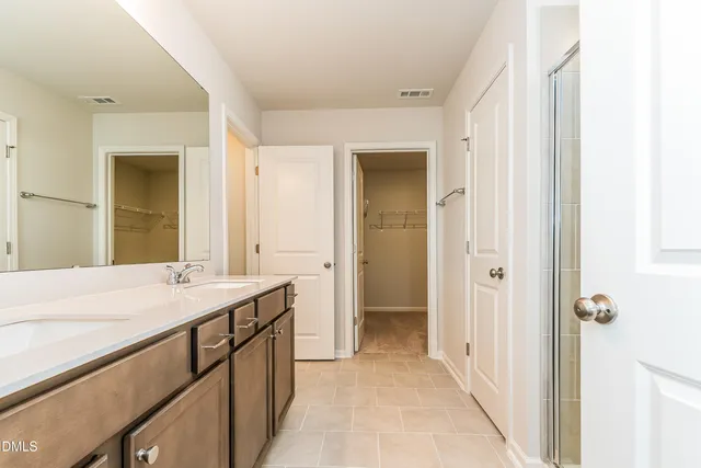 an empty room with closet and a ceiling fan