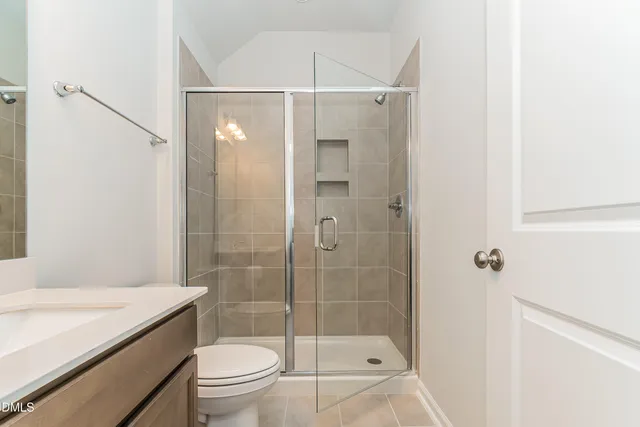 a bathroom with a shower a toilet and sink