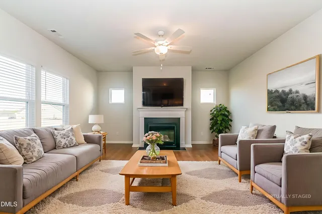 an empty room with windows and a fireplace