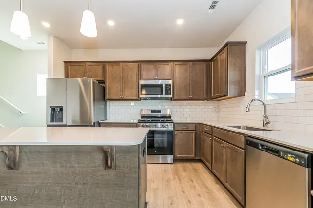 a bedroom with a large bed and a flat tv screen on dresser