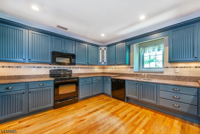 16 Main Street Sparta, NJ 07871 - Photo 7 of 33 a kitchen with granite countertop a stove cabinets and microwave