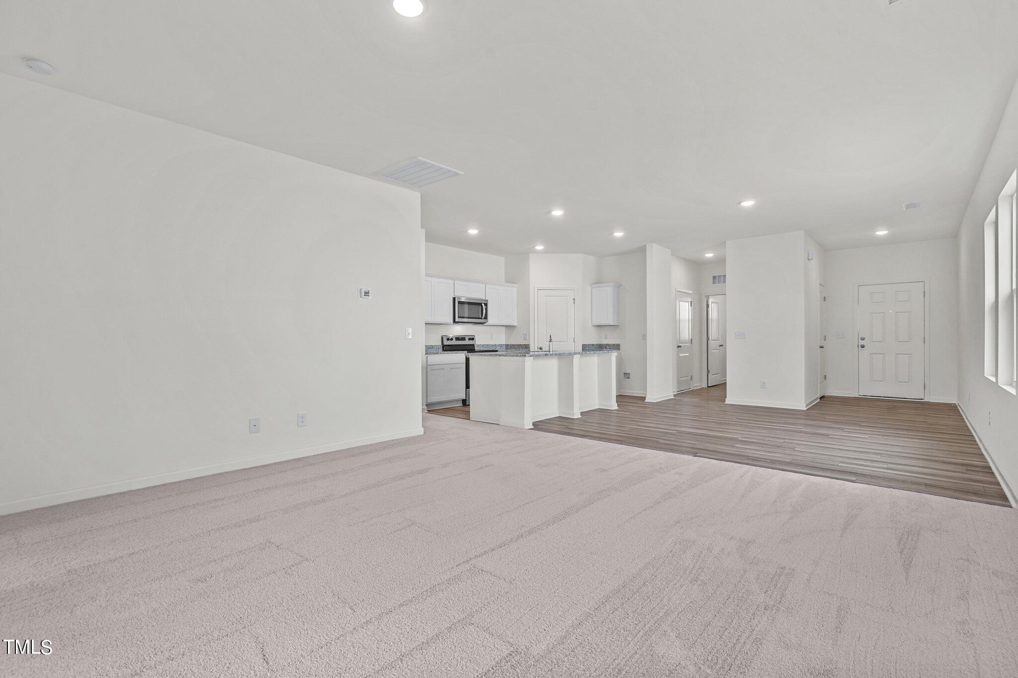 84 Club Road Louisburg, NC 27549 - Photo 11 of 28 a view of kitchen with refrigerator and kitchen island