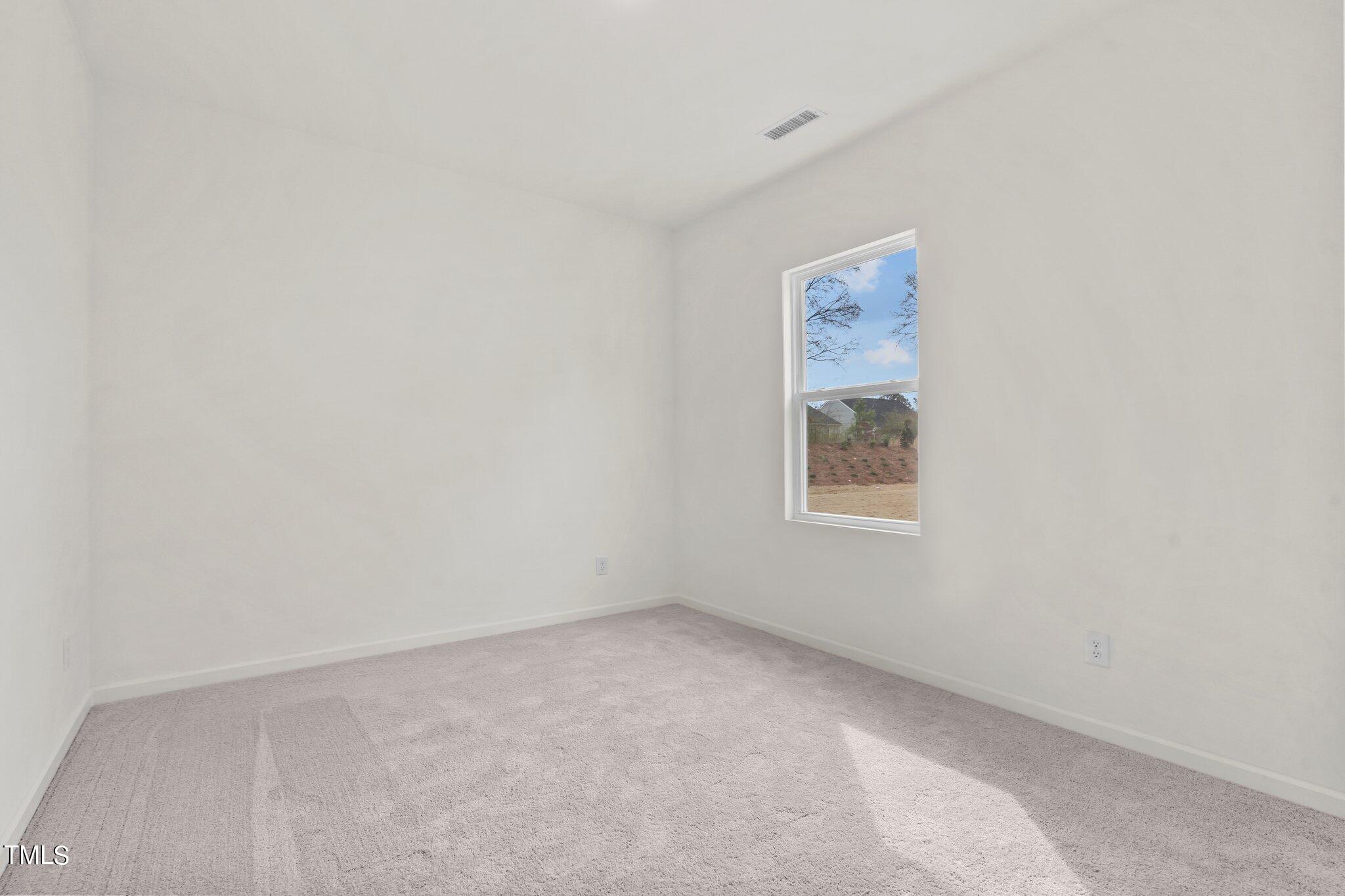 84 Club Road Louisburg, NC 27549 - Photo 19 of 28 a view of an empty room with a window