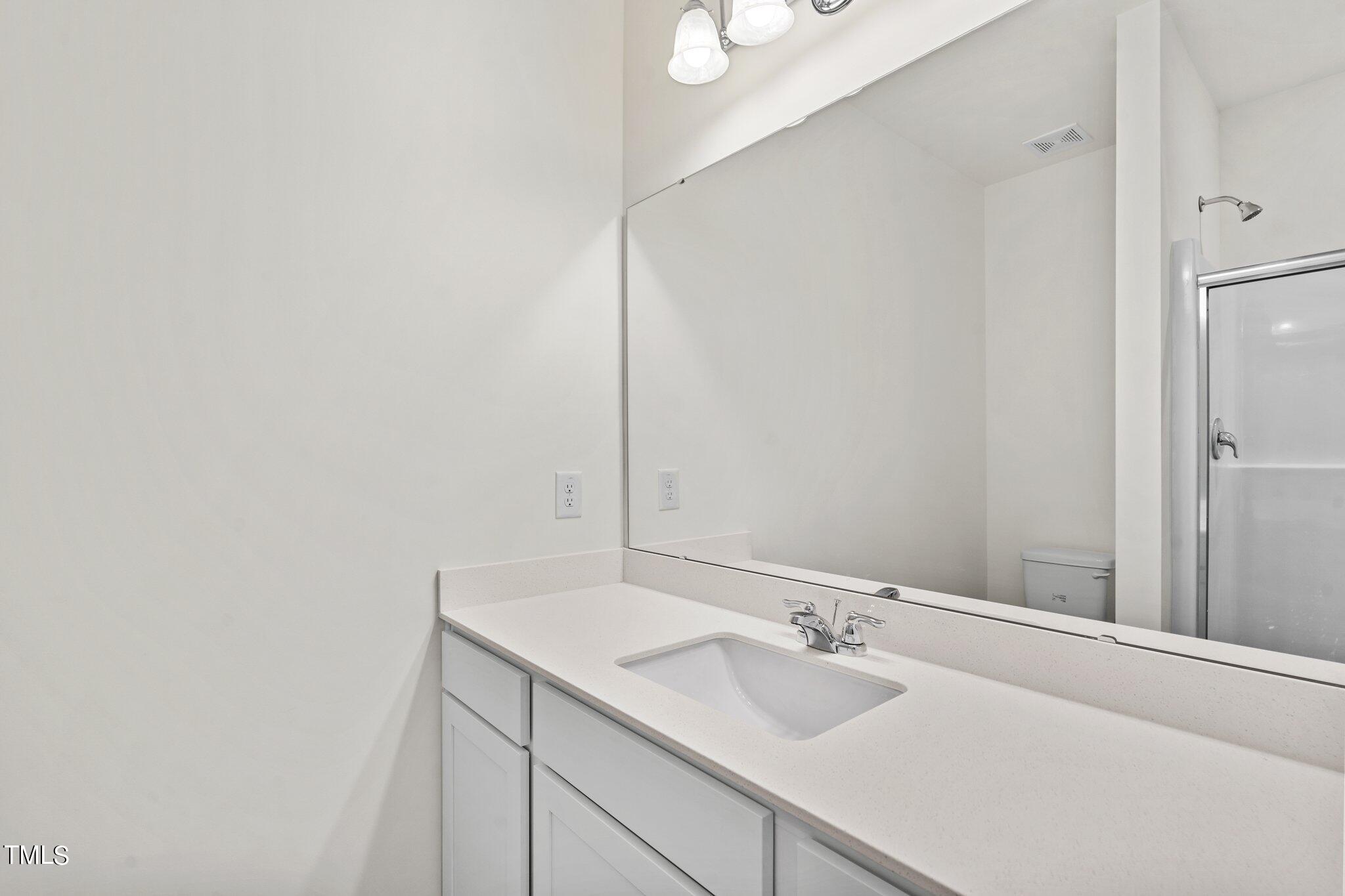 84 Club Road Louisburg, NC 27549 - Photo 20 of 28 a bathroom with a sink and a mirror