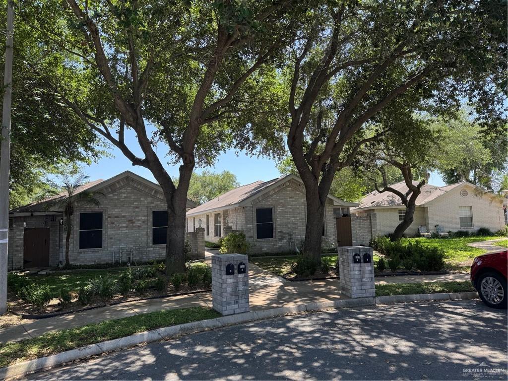 6700 North 8th Street McAllen, TX 78504 - Photo 1 of 16 a front view of a house with garden and trees