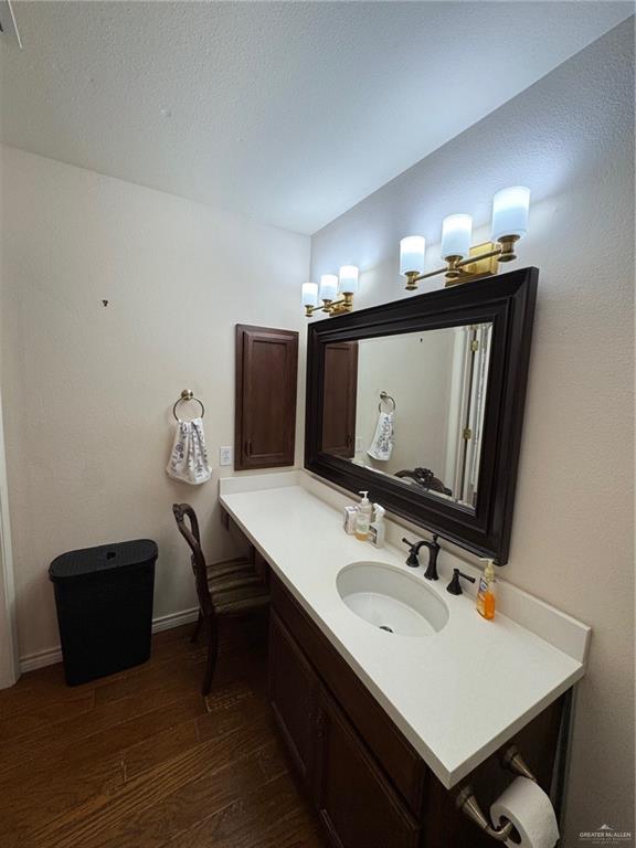 6700 North 8th Street McAllen, TX 78504 - Photo 7 of 16 a bathroom with a sink a light fixture and a mirror