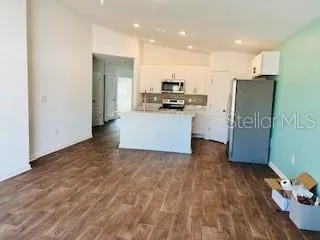 a kitchen with stainless steel appliances a refrigerator and a stove top oven