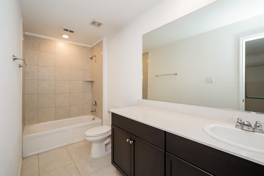 14841 Firerock Road Haslet, TX 76052 - Photo 16 of 18 a bathroom with a sink a toilet and shower