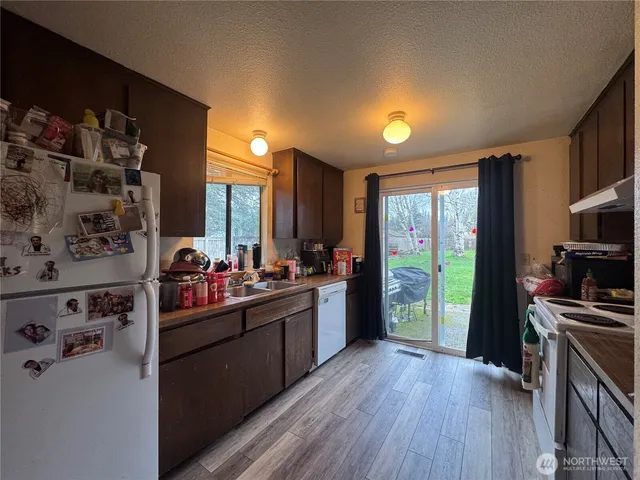 a kitchen with stainless steel appliances a sink stove and refrigerator