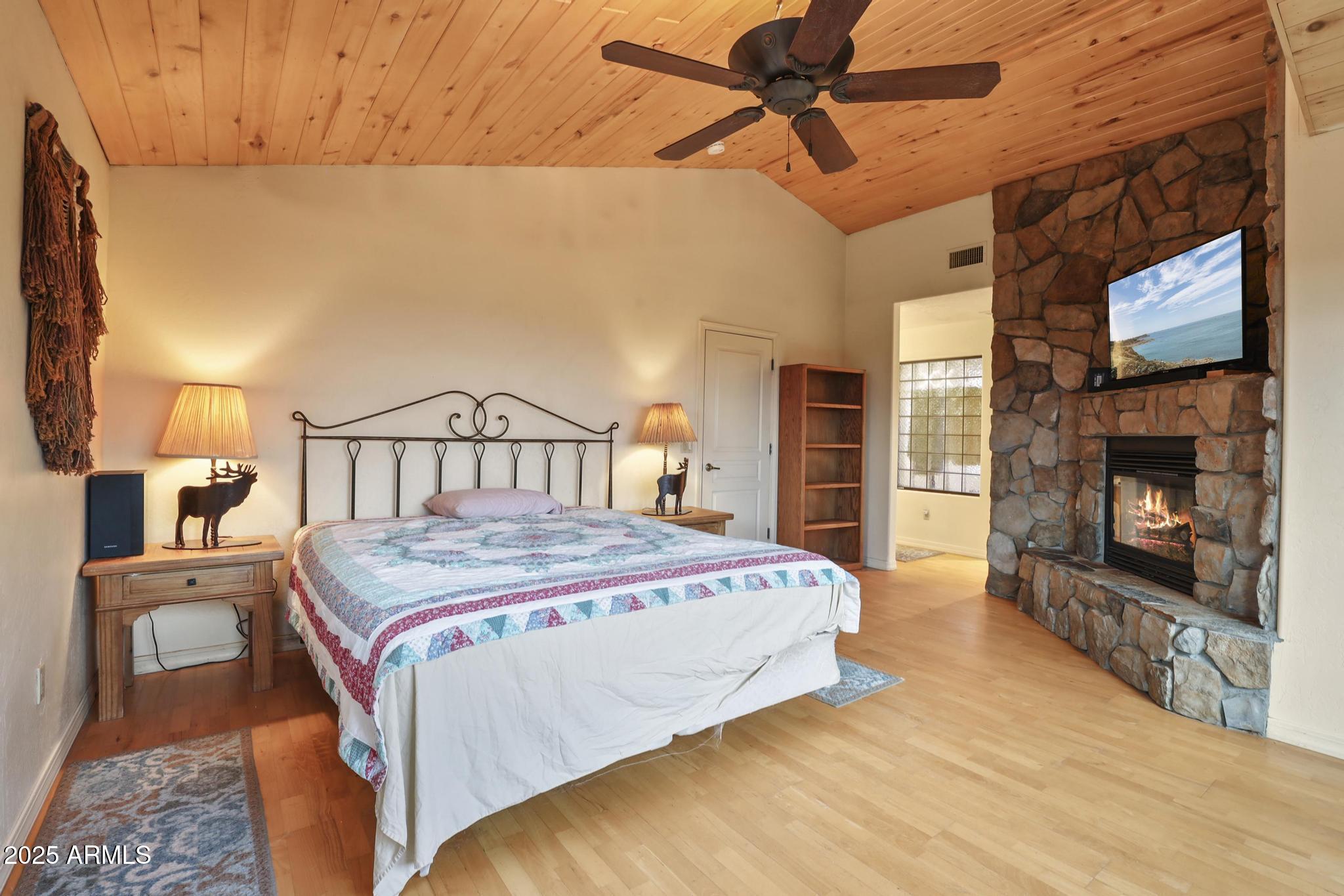 131 West Hunt Ranch Road Pine, AZ 85544 - Photo 23 of 65 a bedroom with a bed and a fireplace