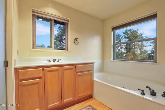 a spacious bathroom with a sink and a large mirror