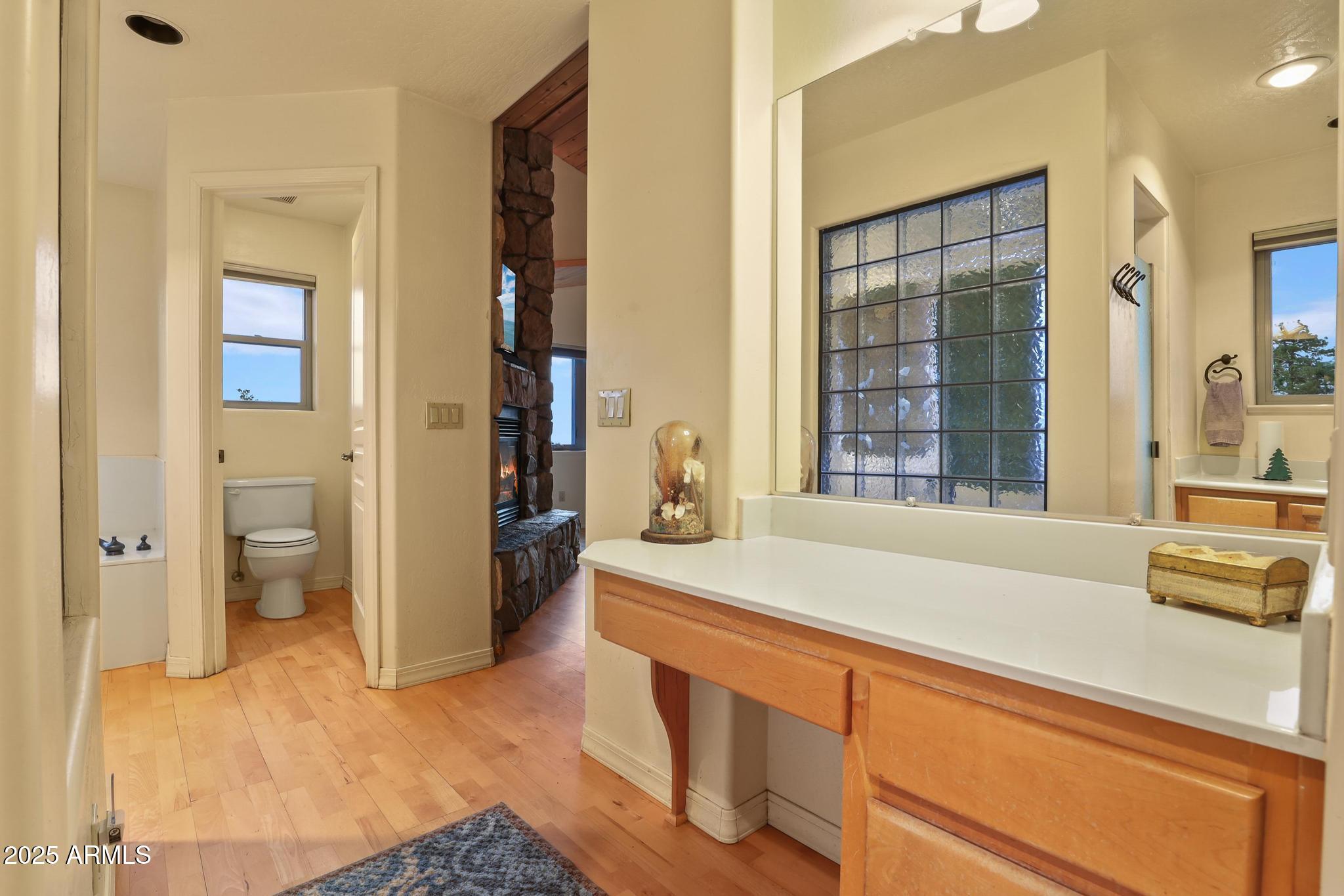 131 West Hunt Ranch Road Pine, AZ 85544 - Photo 26 of 65 a spacious bathroom with a sink and a large mirror