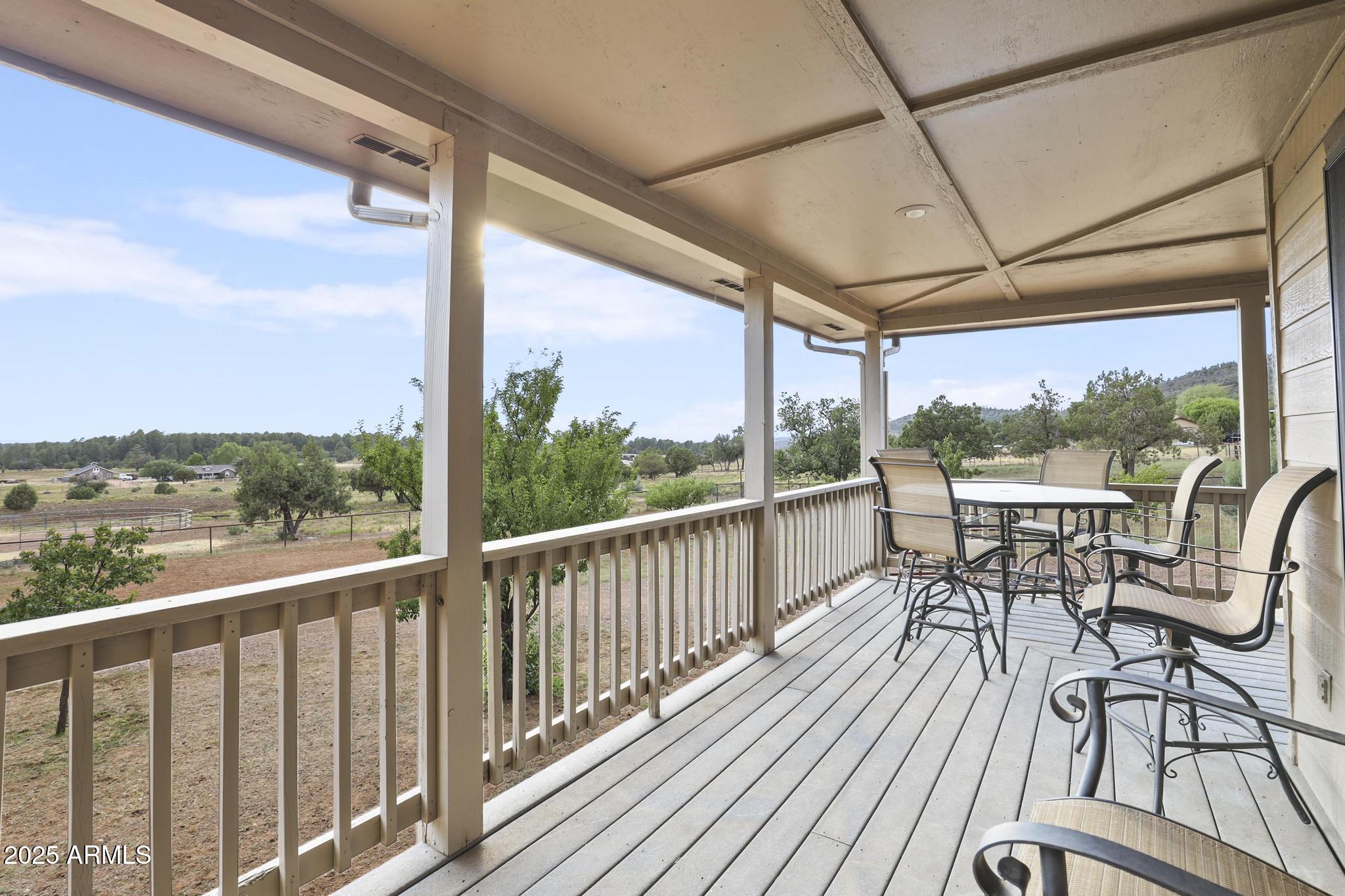 131 West Hunt Ranch Road Pine, AZ 85544 - Photo 3 of 65 a view of a balcony with chairs and wooden floor
