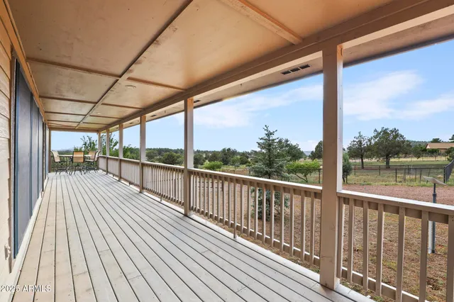 a view of a porch with wooden floor and outdoor space