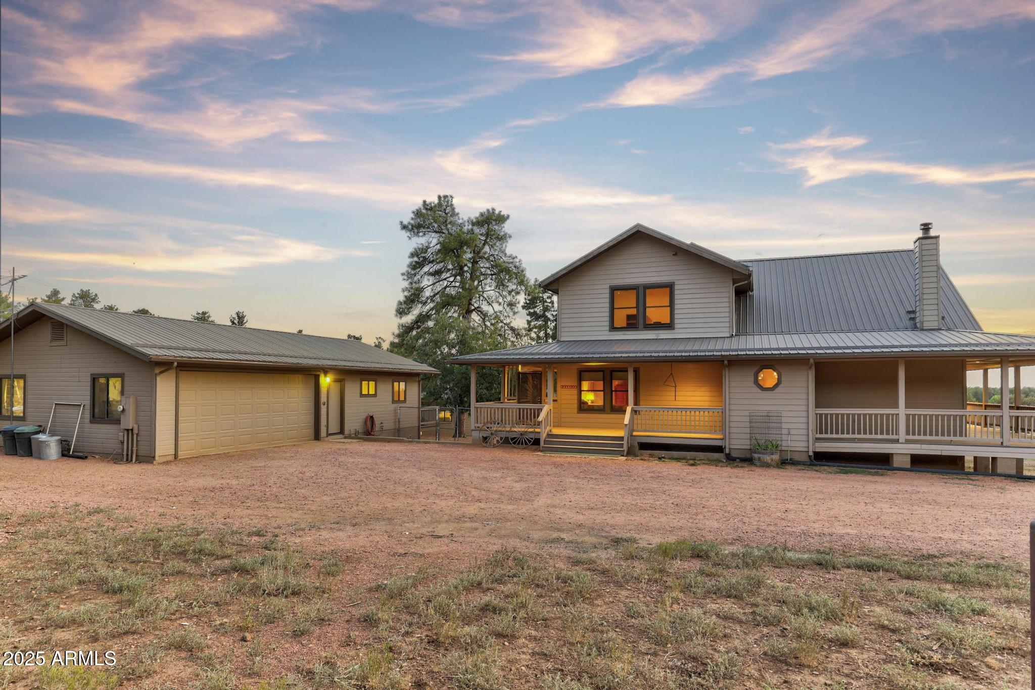 131 West Hunt Ranch Road Pine, AZ 85544 - Photo 58 of 65 a front view of a house with a yard and garage