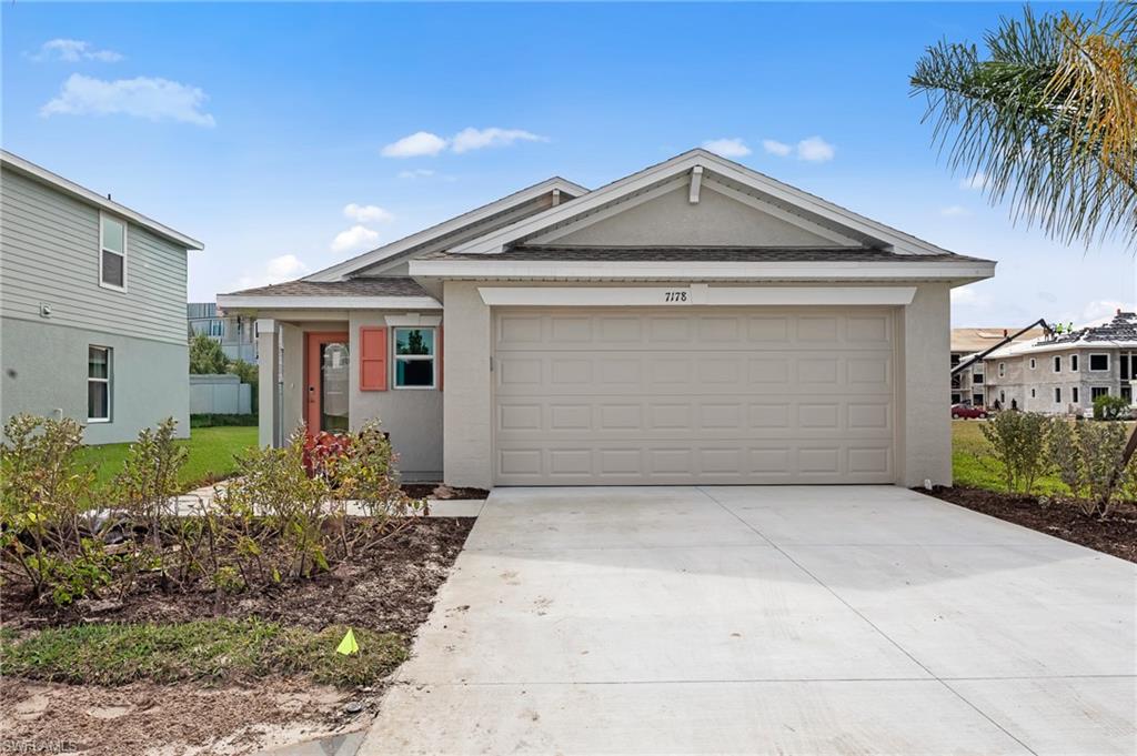 7178 Sugar Pine Way Fort Myers, FL 33966 - Photo 2 of 33 a front view of a house with garden