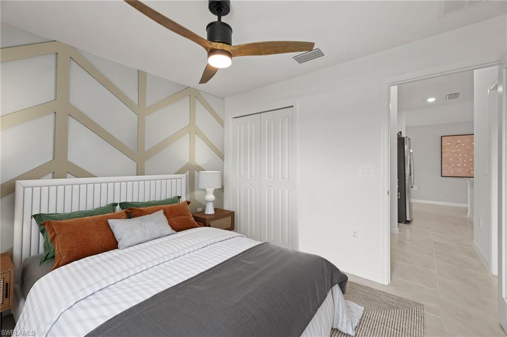 7178 Sugar Pine Way Fort Myers, FL 33966 - Photo 21 of 33 a bedroom with a bed and a chandelier