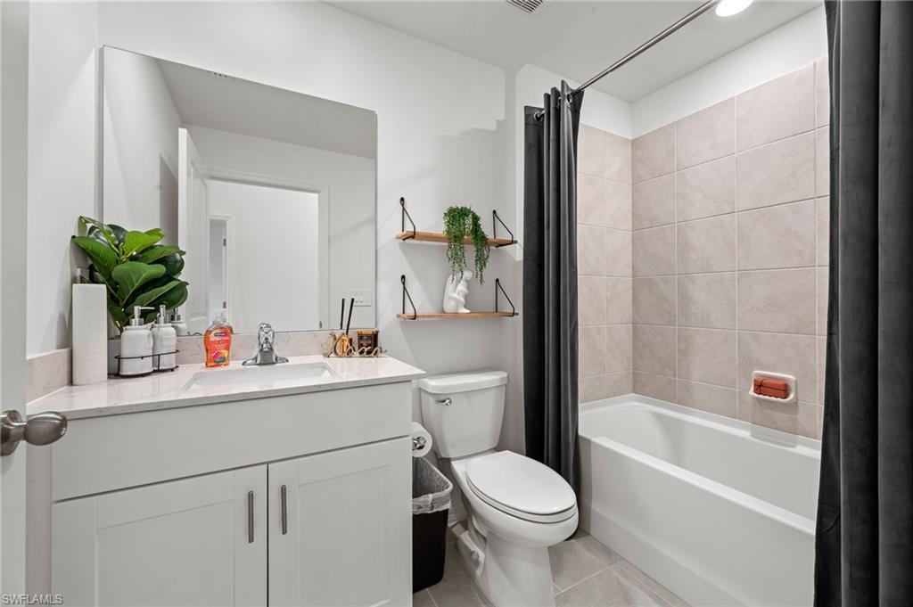 7178 Sugar Pine Way Fort Myers, FL 33966 - Photo 22 of 33 a bathroom with a sink a toilet and shower