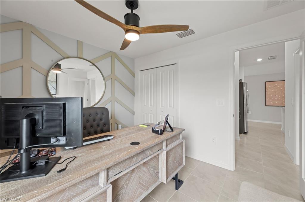 7178 Sugar Pine Way Fort Myers, FL 33966 - Photo 26 of 33 a bedroom with a bed and a mirror on the dresser