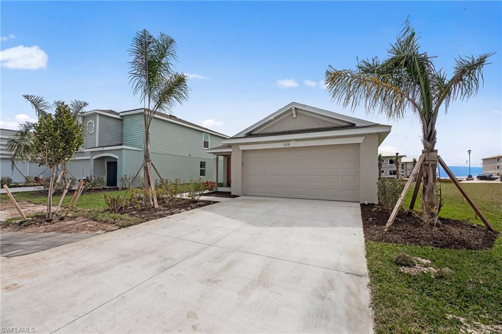 7178 Sugar Pine Way Fort Myers, FL 33966 - Photo 29 of 33 a view of a house with a yard and palm trees