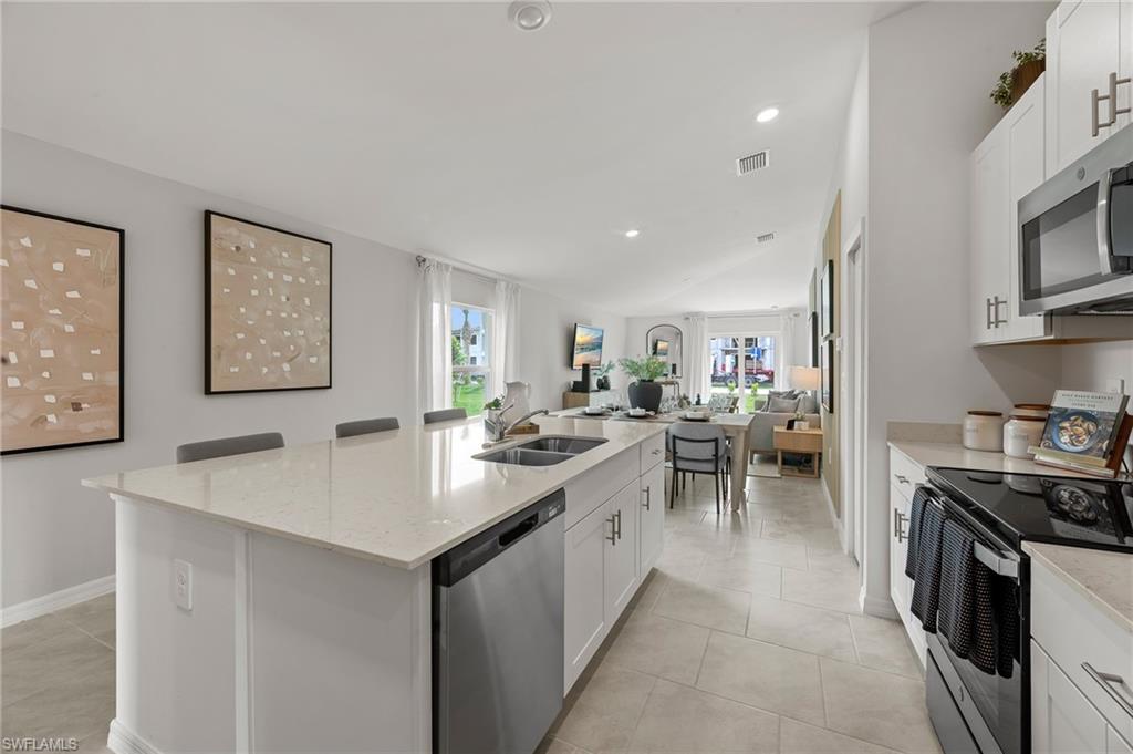 7178 Sugar Pine Way Fort Myers, FL 33966 - Photo 32 of 33 a kitchen with appliances a sink and cabinets