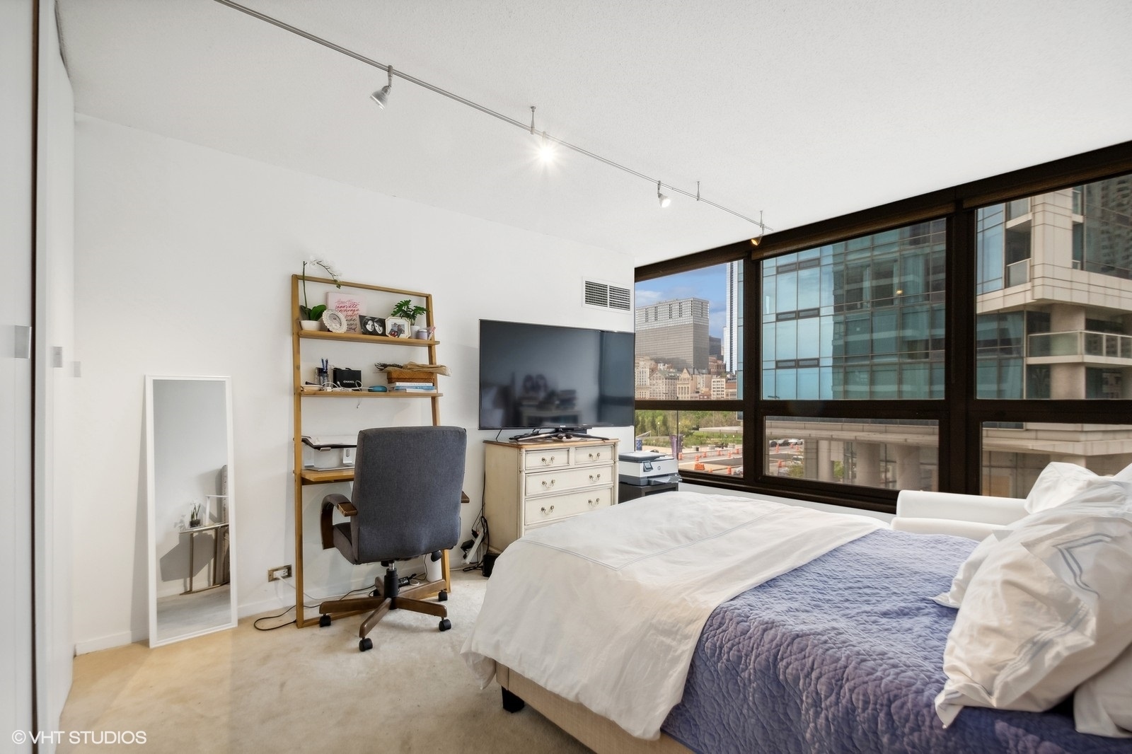 Undisclosed Address Chicago, IL 60601 - Photo 7 of 19 a bedroom with a bed and a flat screen tv