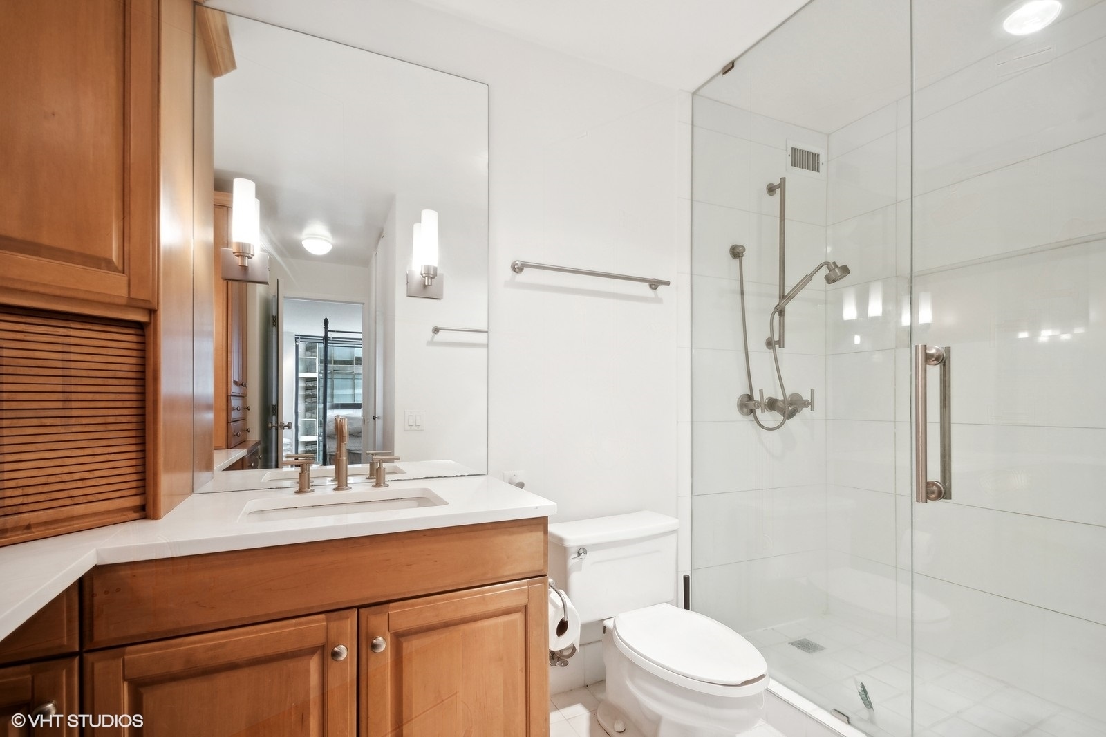 Undisclosed Address Chicago, IL 60601 - Photo 10 of 19 a bathroom with a sink a toilet a mirror and shower