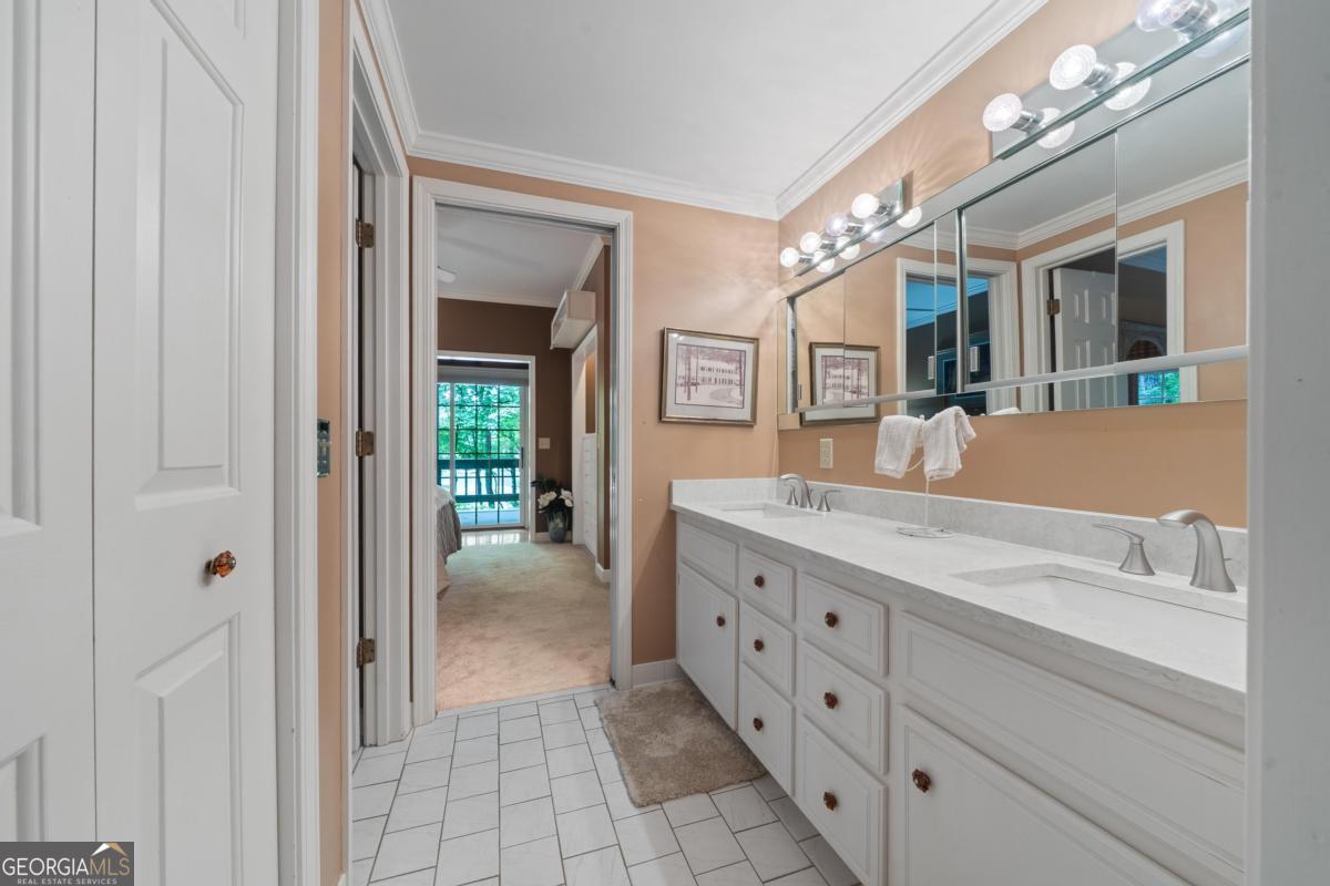 1031 Old Still Road Greensboro, GA 30642 - Photo 55 of 73 a bathroom with a granite countertop sink vanity and mirror