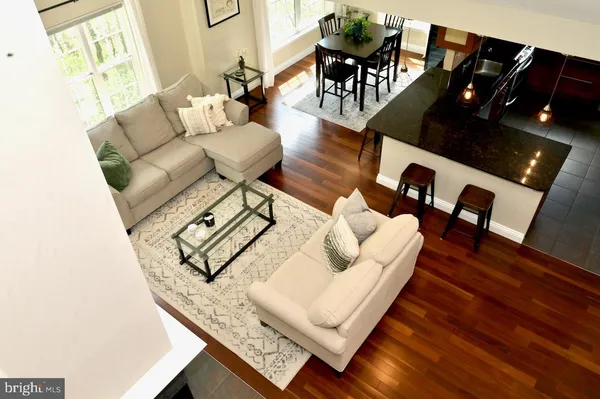 a living room with furniture a fireplace and a large window