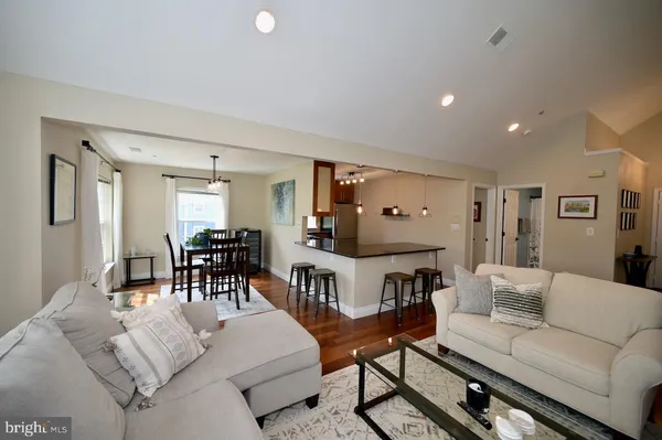 a living room with fireplace furniture and a wooden floor