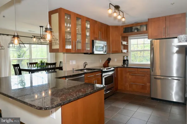 a kitchen with stainless steel appliances granite countertop a sink and cabinets