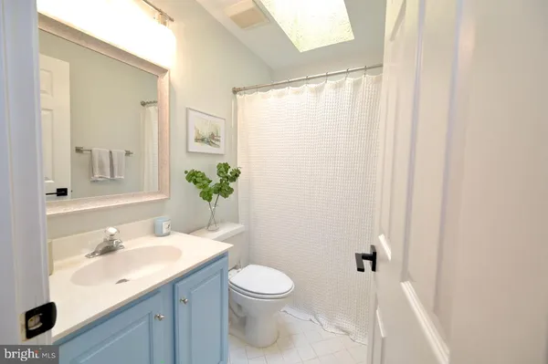 a bathroom with a glass shower door