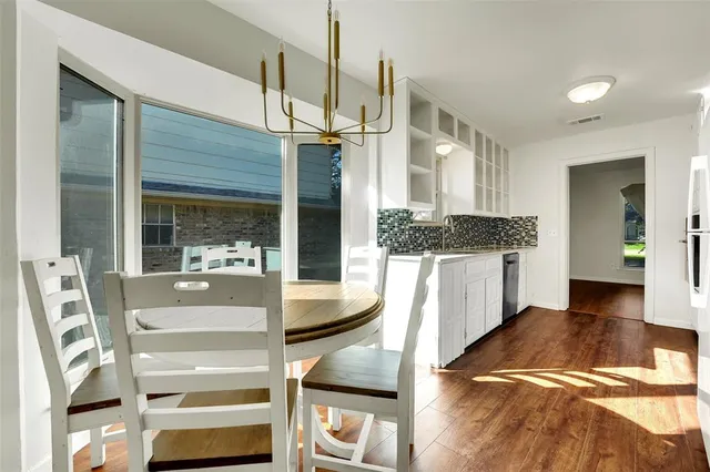 a view of a bedroom with furniture and wooden floor