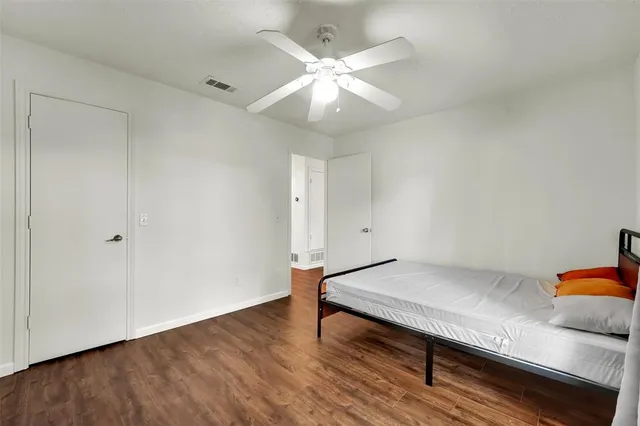 a bathroom with a toilet sink vanity tub and mirror