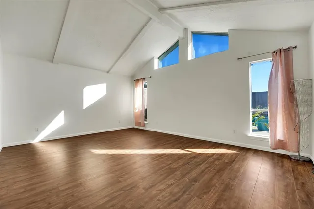 an empty room with wooden floor and closet