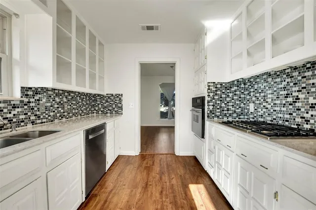 a kitchen with kitchen island granite countertop wooden cabinets and counter space