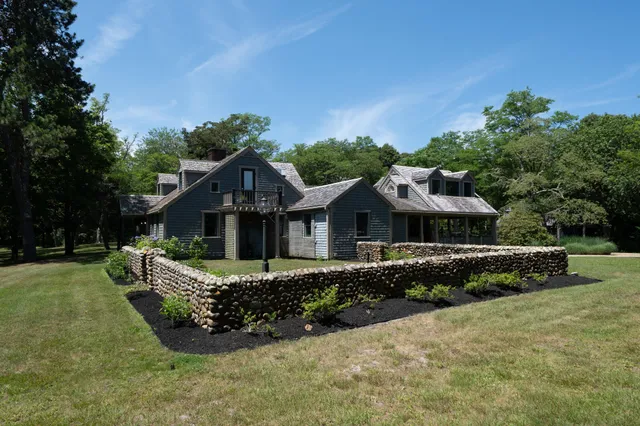 a front view of a house with a garden and plants