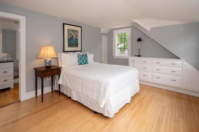 a bathroom with a sink a toilet a mirror and shower