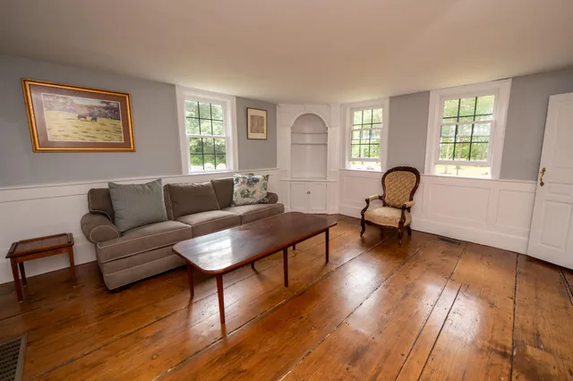 a room with furniture pool table and wooden floor