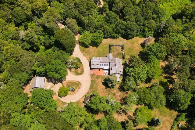 a front view of a house with a yard table and chairs