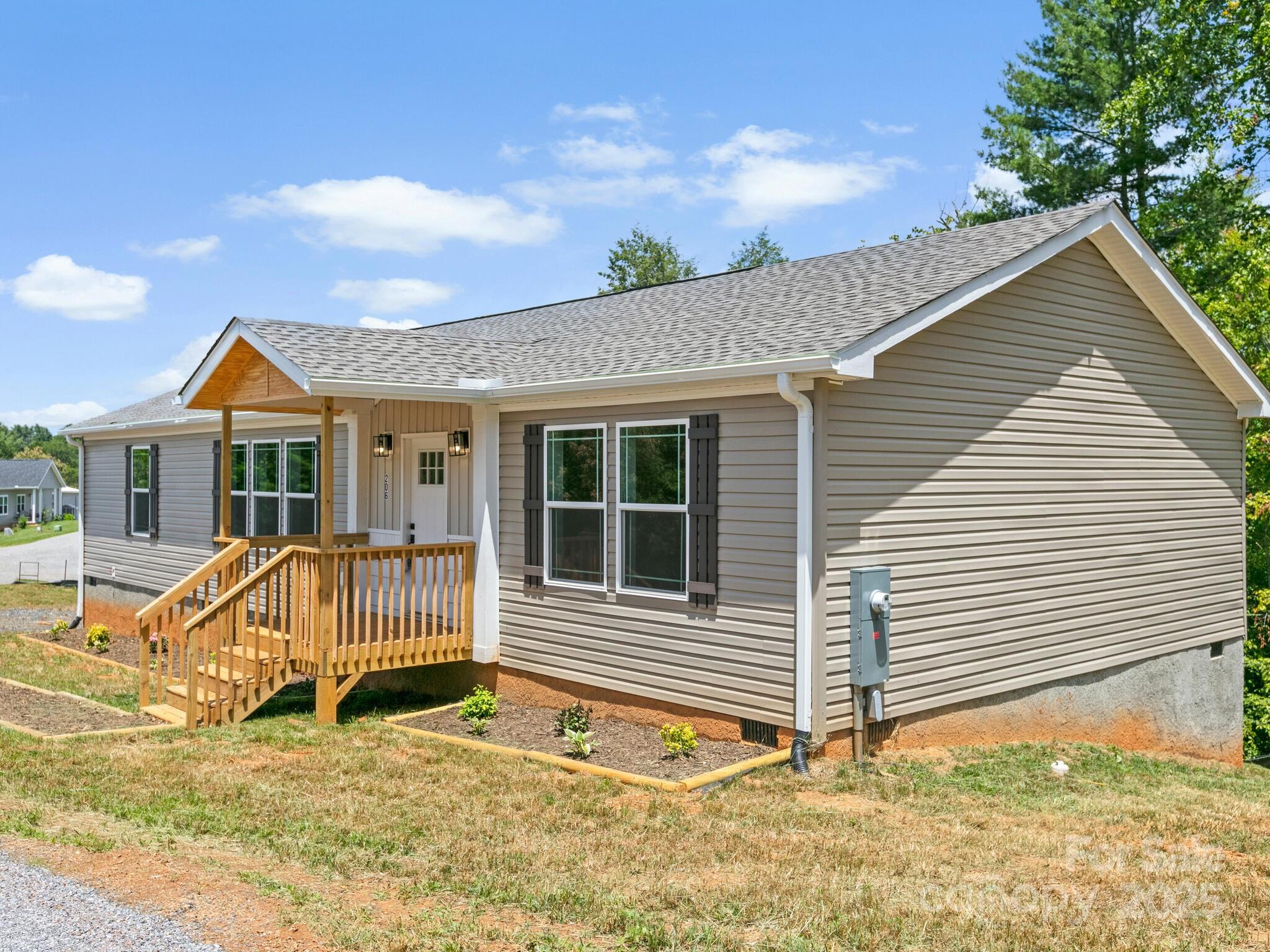 a view of house with backyard and outdoor seating