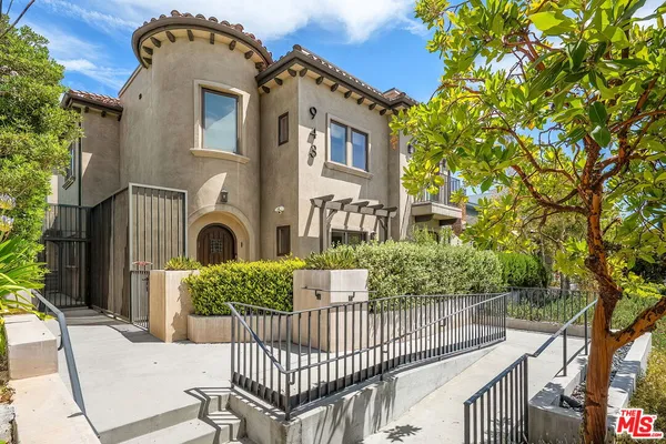 a front view of a house with iron fence