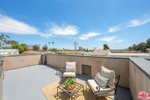 a view of a balcony with chairs