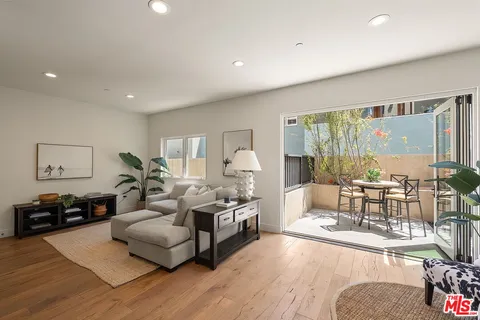 a living room with furniture fireplace and a large window