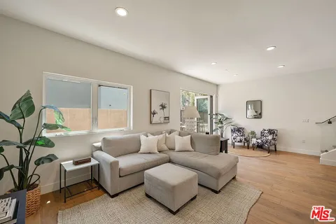 a living room with furniture and a potted plant