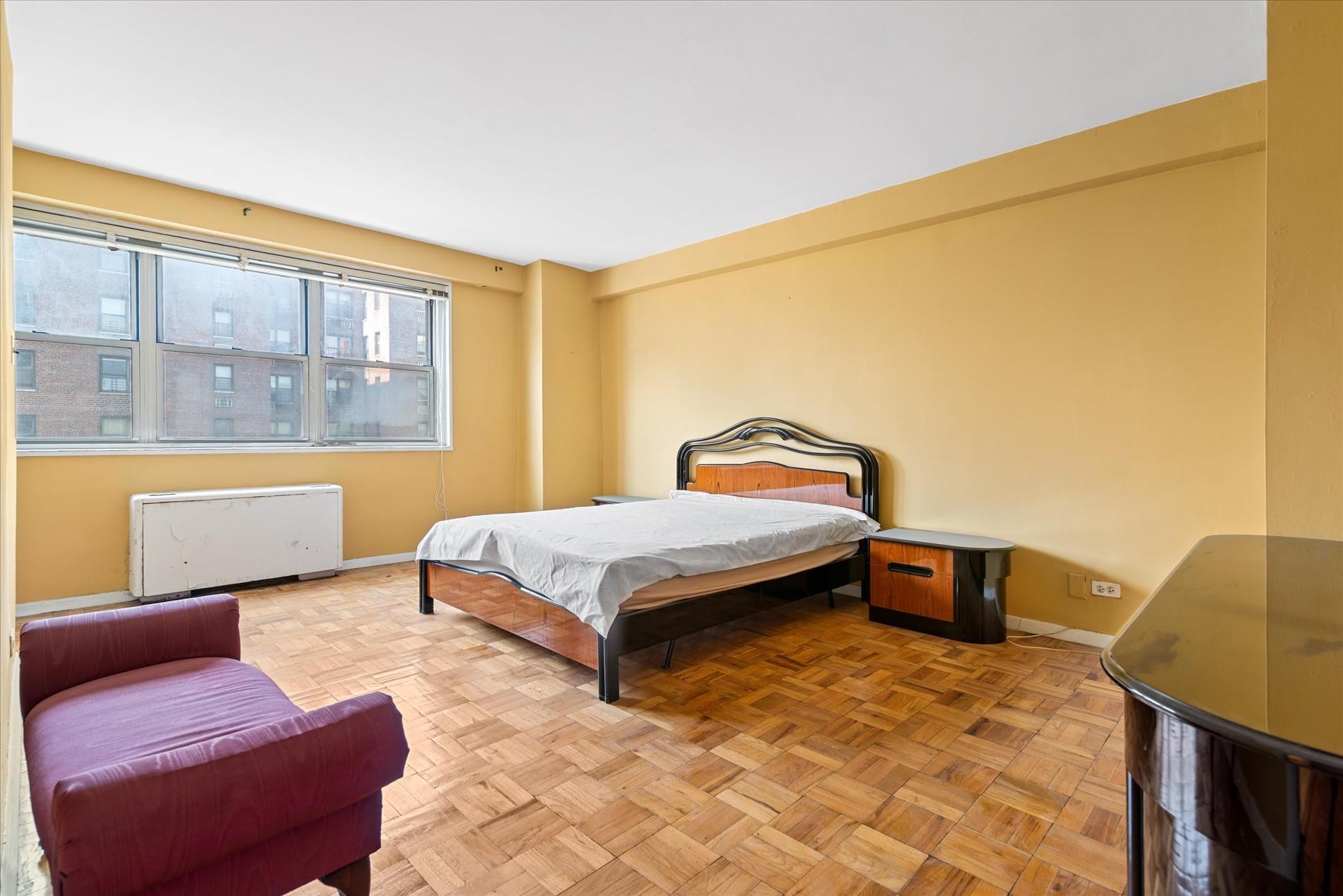 102-30 66th Road, Unit 4B Queens, NY 11375 - Photo 11 of 26 a bedroom with a bed and wooden floor