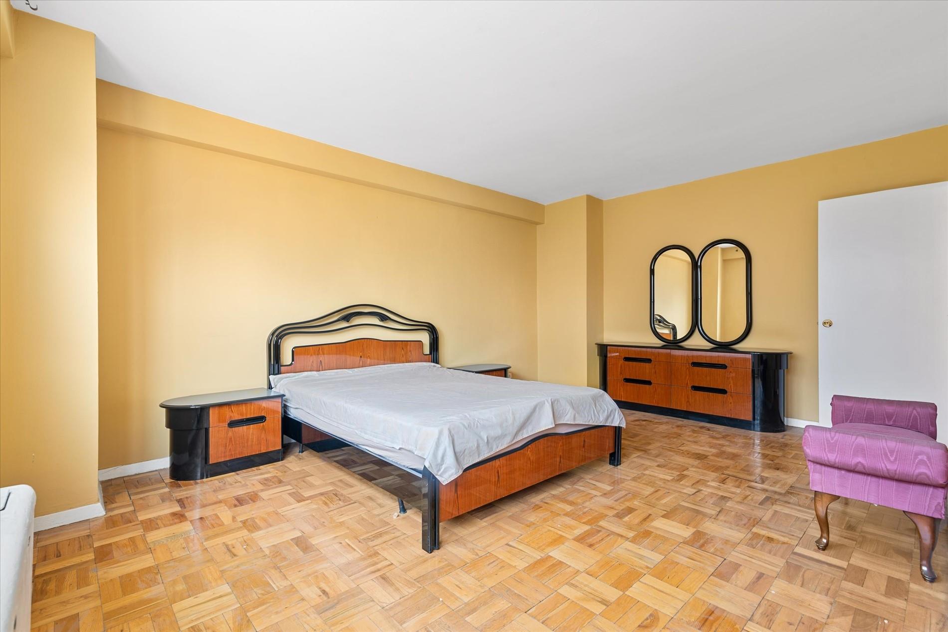 102-30 66th Road, Unit 4B Queens, NY 11375 - Photo 13 of 26 a bedroom with a bed and dresser with rug