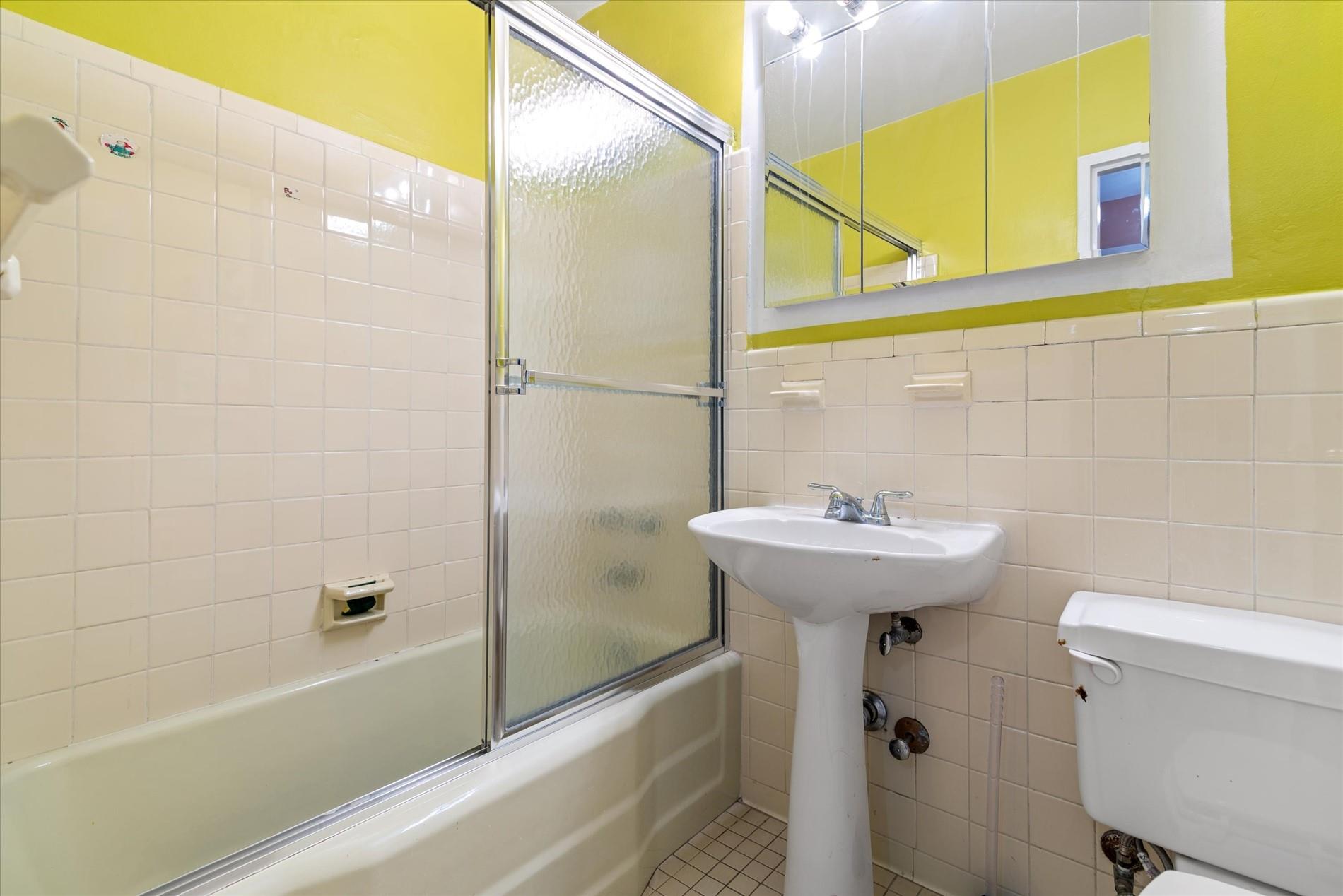 102-30 66th Road, Unit 4B Queens, NY 11375 - Photo 16 of 26 a bathroom with a sink a toilet and bathtub